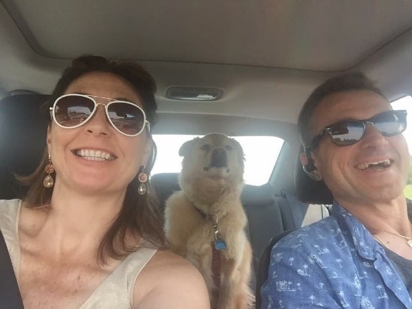 On the left side Lydia Kulbida and on the right side of photo Nick Kulbida and the middle their dog are traveling in the car.